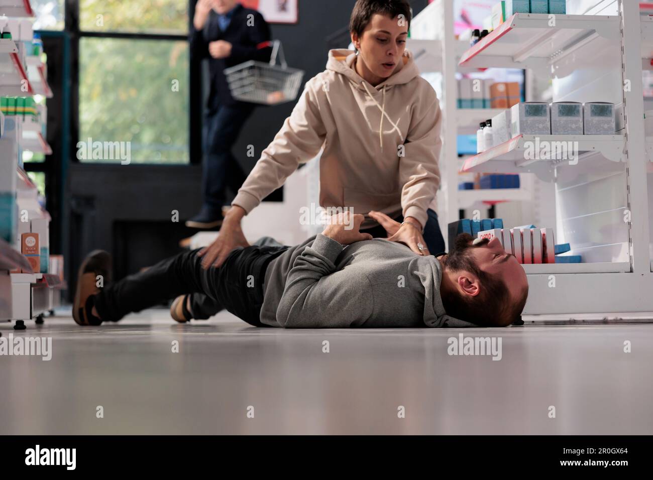 Woman helping man having foaming at mouth and convulsion during