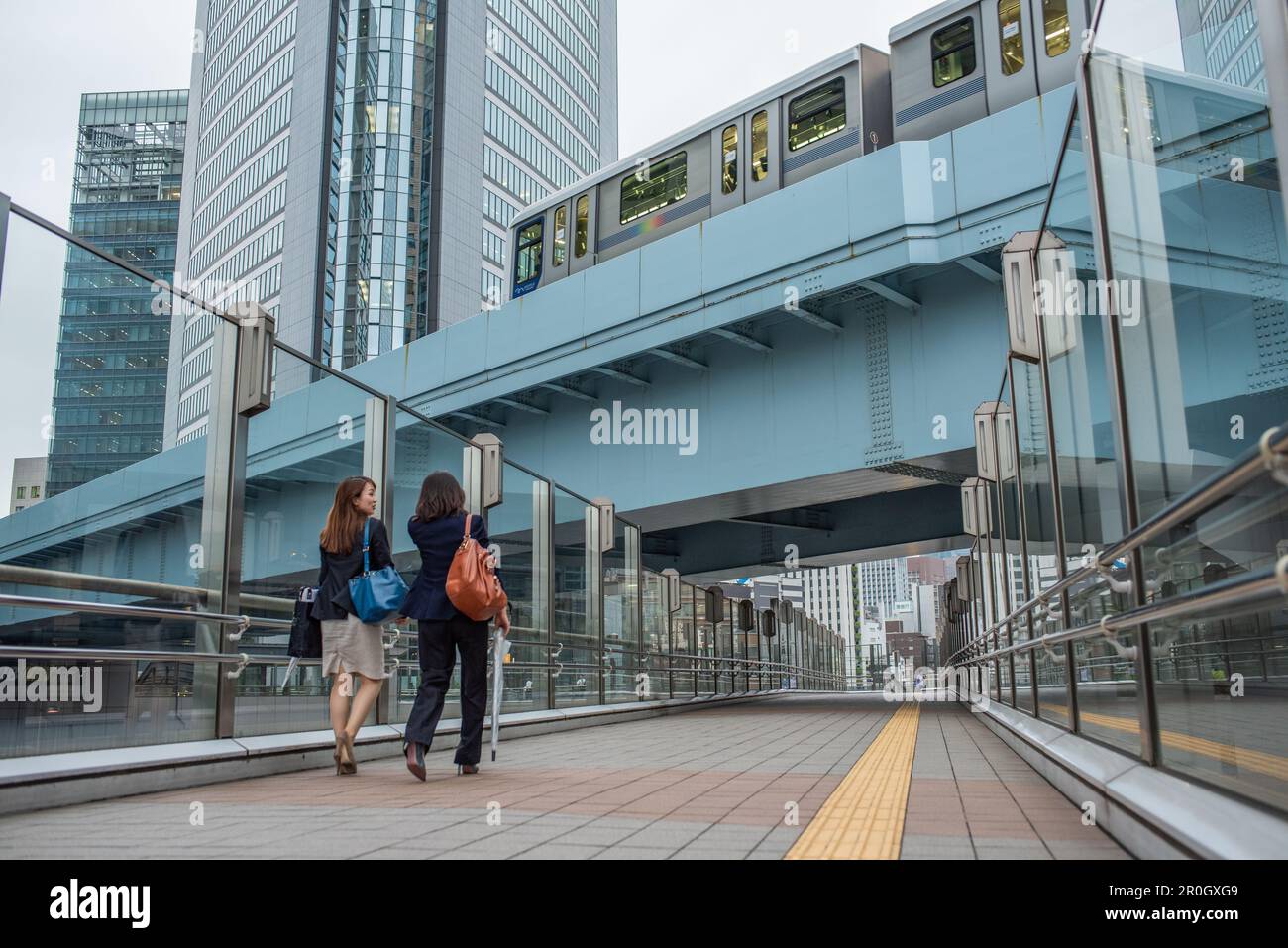 Two women commute from work in modern Tokyo Stock Photo - Alamy