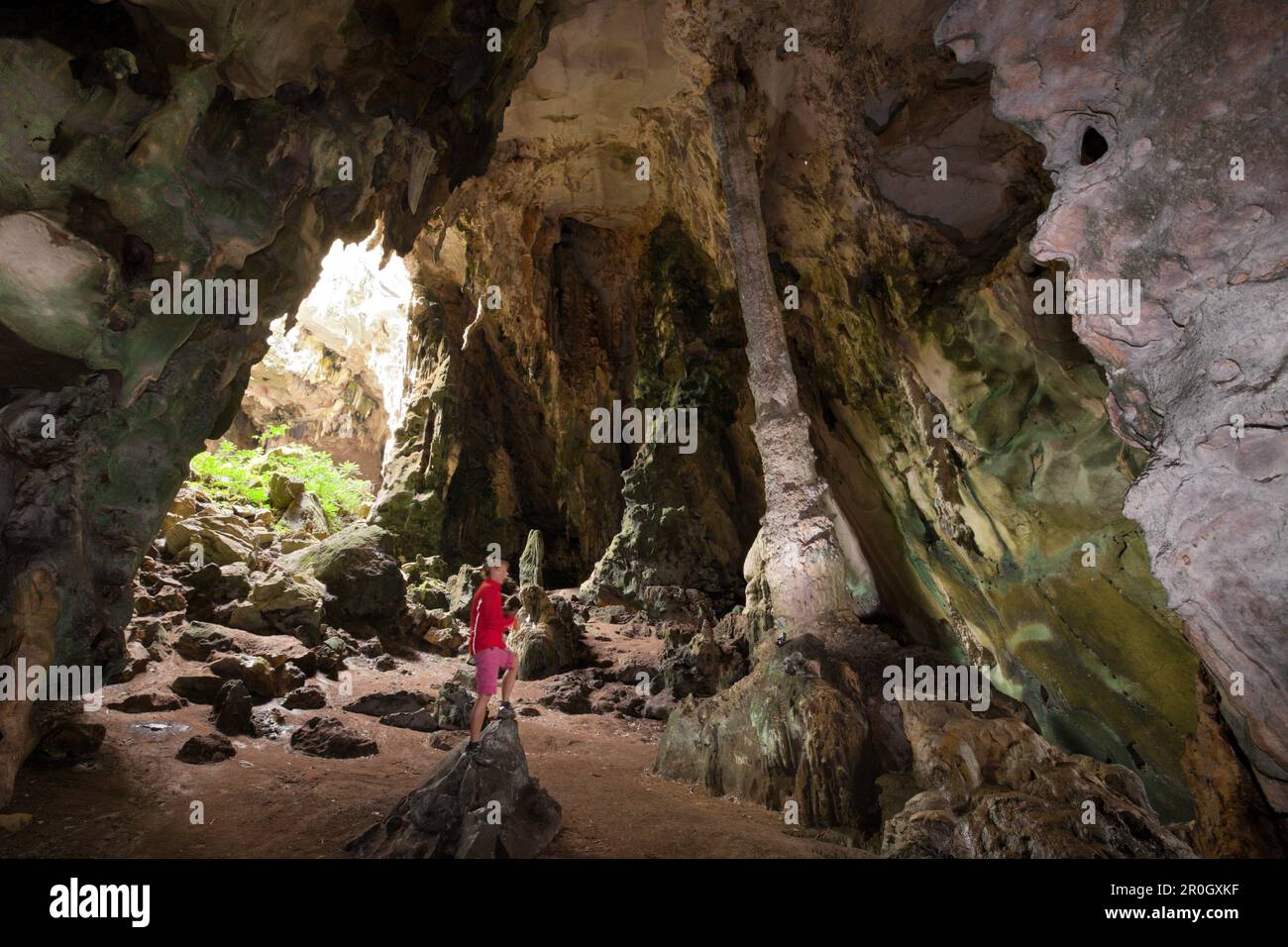 Tourist inside Kotilola Cave, Baliem Valley, West Papua, Papua New Guinea, New Guinea, Oceania Stock Photo