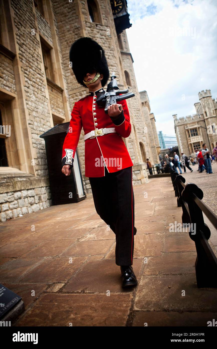 Coldstream Guard sentry patrolling the entrance to the Jewel House, Tower of London, London, England Stock Photo