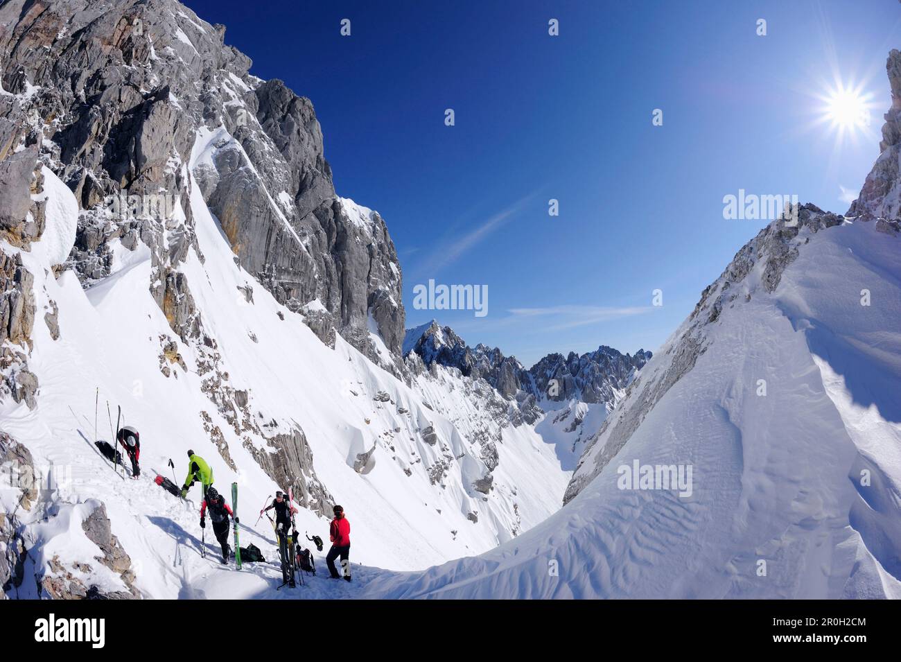 Group of people backcountry skiing, preparing for the downhill ...