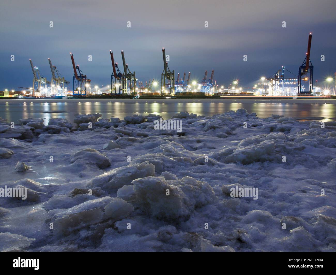 Frozen Elbe river with Waltershof container terminal in the evening, Hanseatic City of Hamburg, Germany, Europe Stock Photo