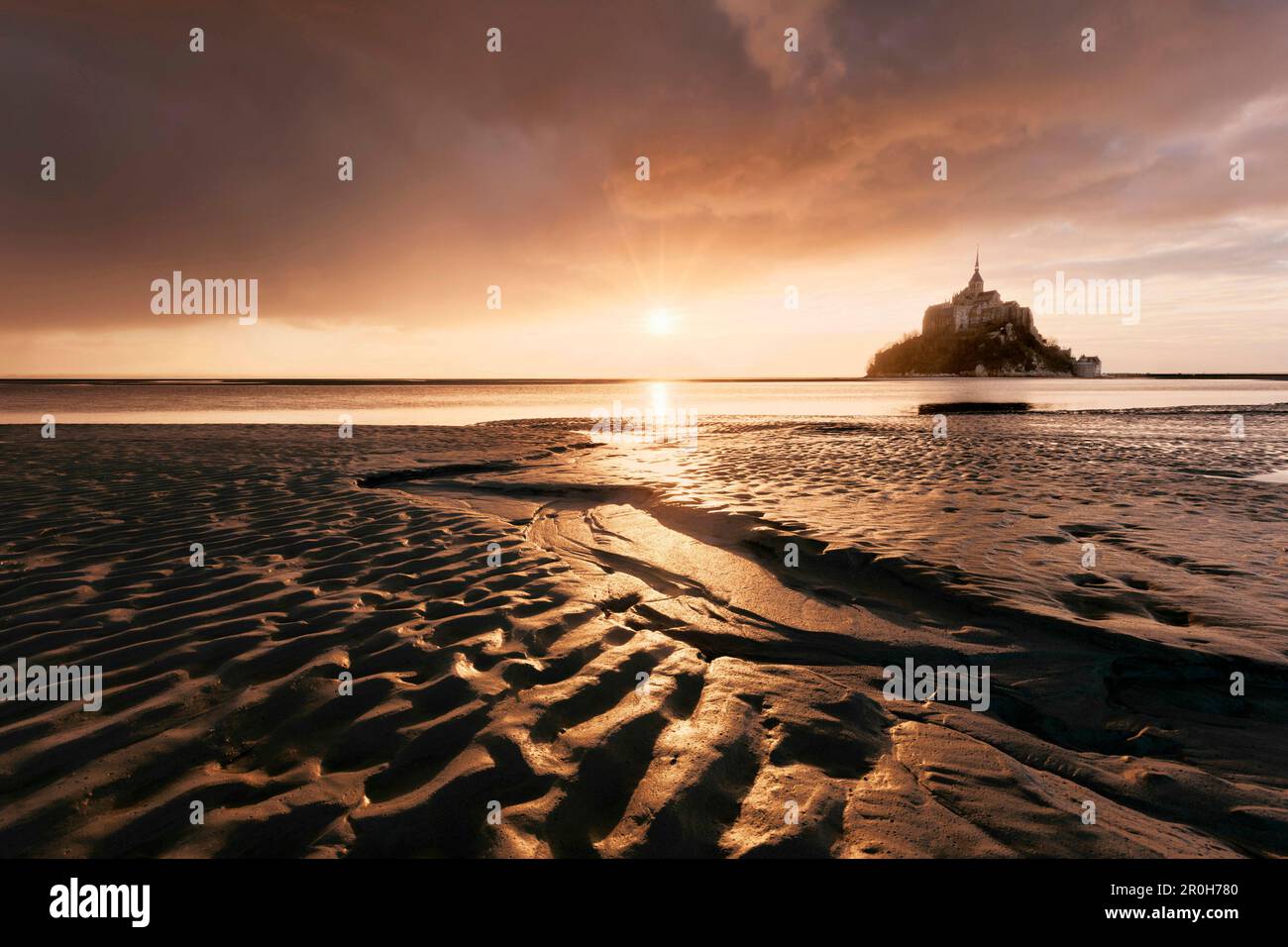 Impressive sunset above the famous monastery MontSaint Michel, built