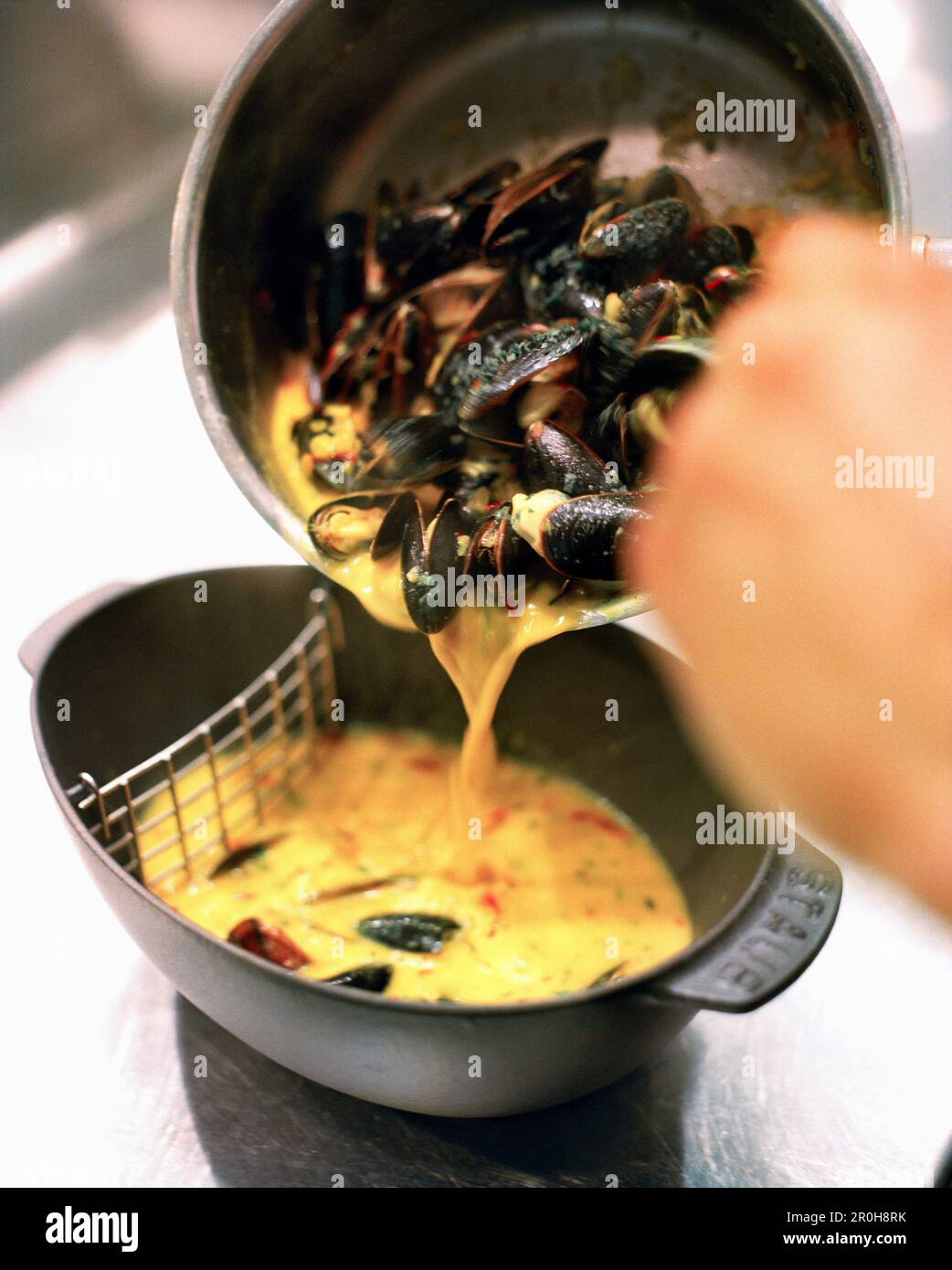 USA, Nevada, Las Vegas, plating the mussells dish at Bouchon Restaurant. Stock Photo
