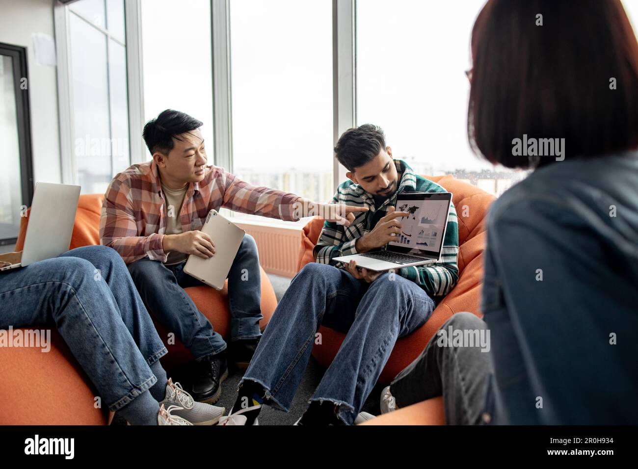Focus on multicultural men talking about graphic materials on computer ...