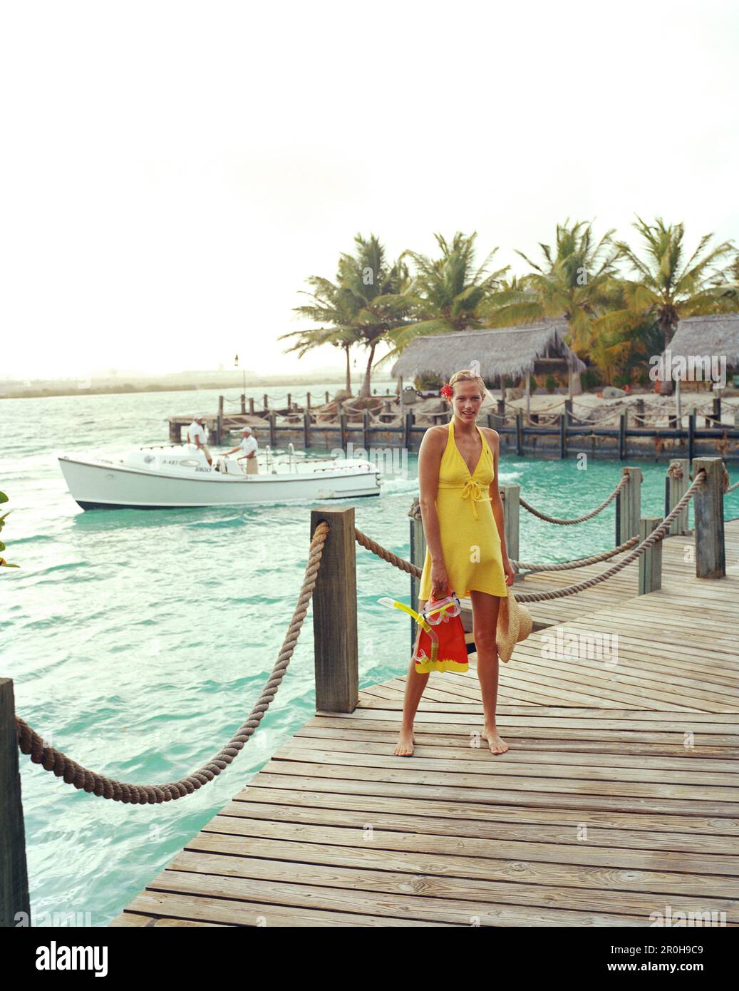 ARUBA, portrait of young woman standing on a dock with her snorkel gear, Renaissance Island Stock Photo