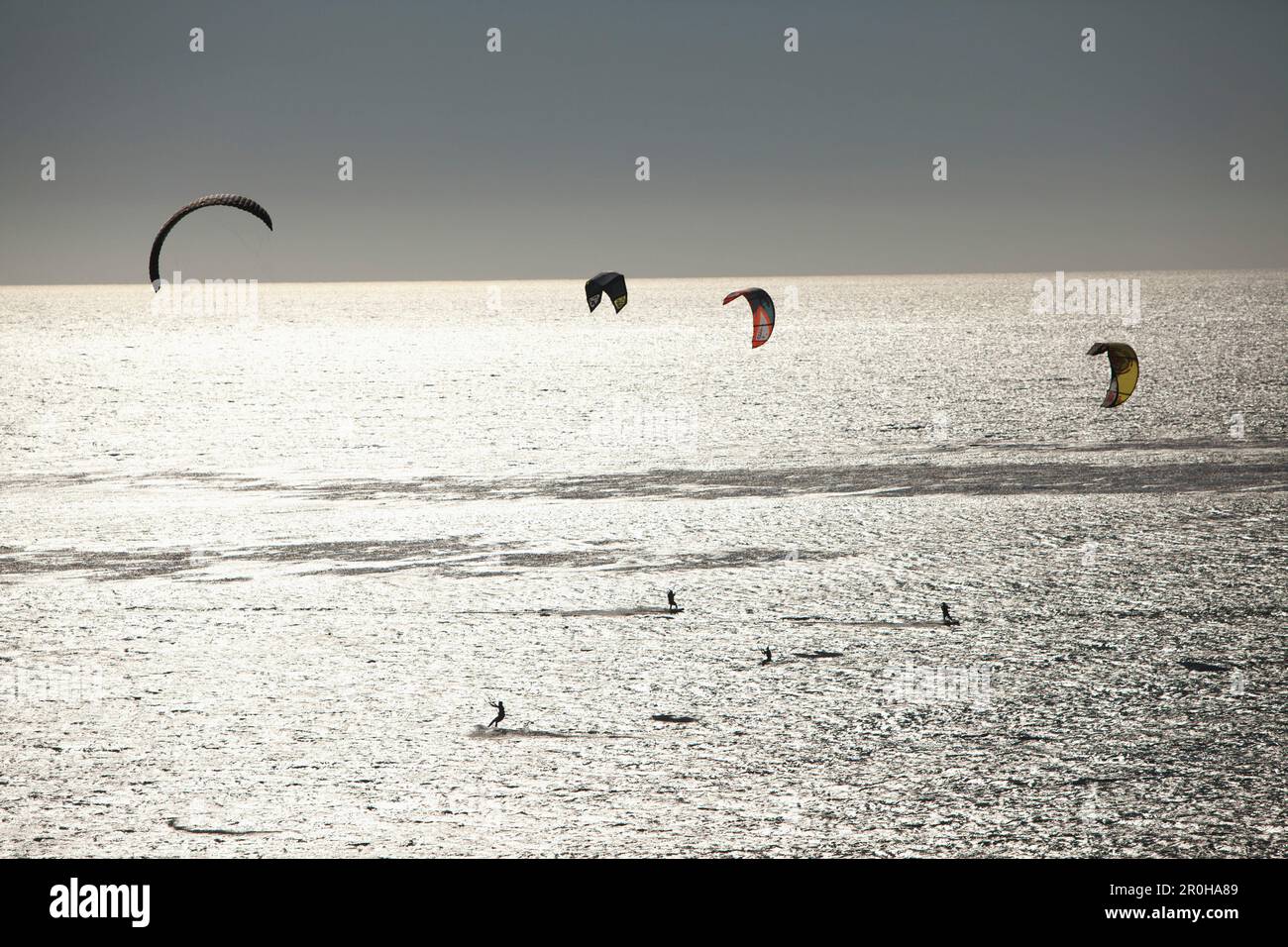 USA, California, Malibu, kite surfers play in the Pacific off of Broad Beach Stock Photo