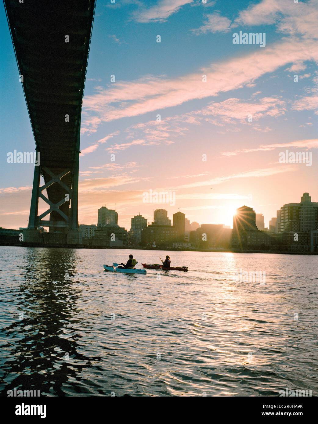 USA, California, San Francisco, a man and woman kayak in the San Francisco Bay under the Bay Bridge, the city of San Francisco in the distance Stock Photo