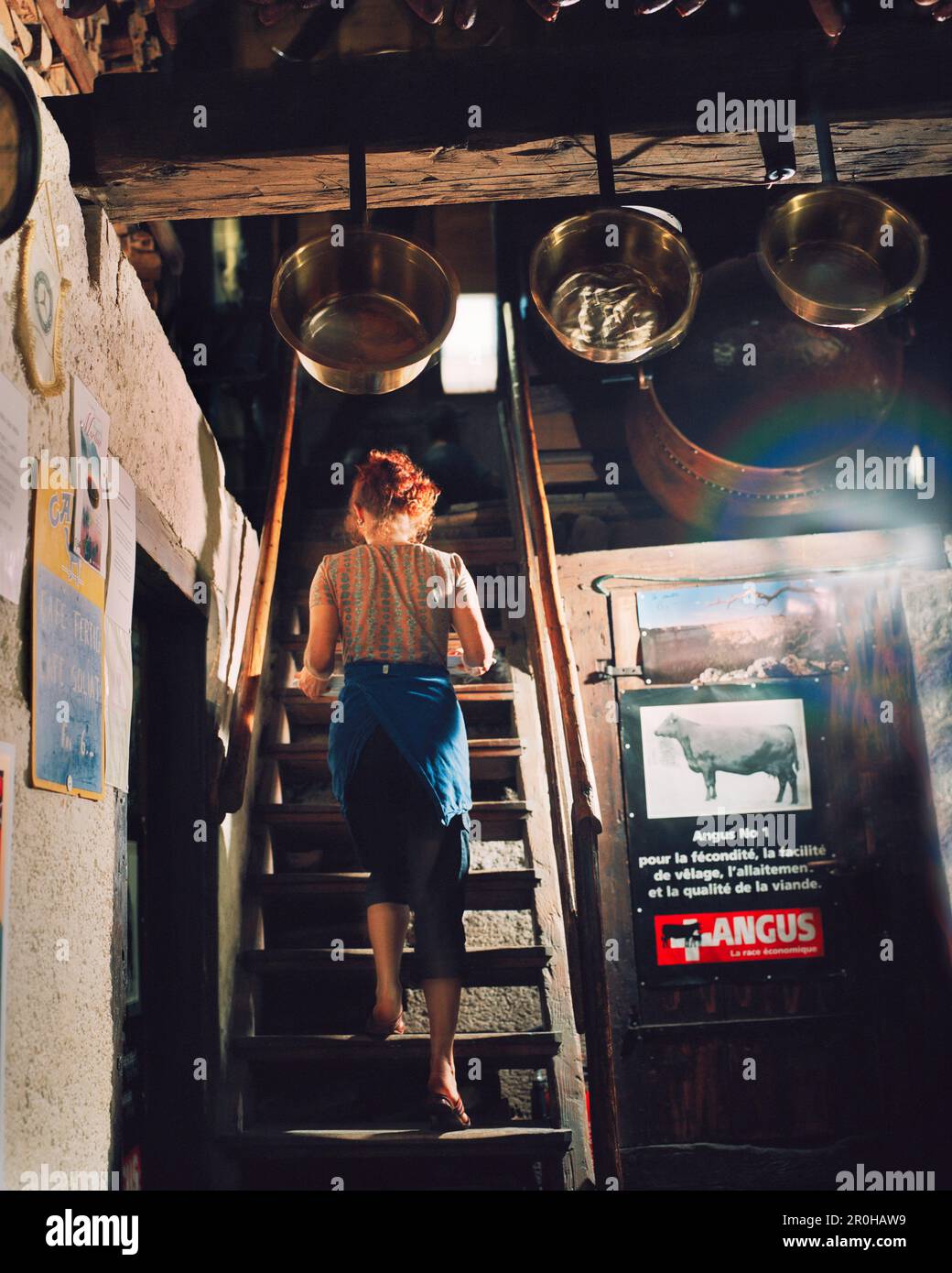 FRANCE, ValdeTravers, carries cheese fondue up stairs guests