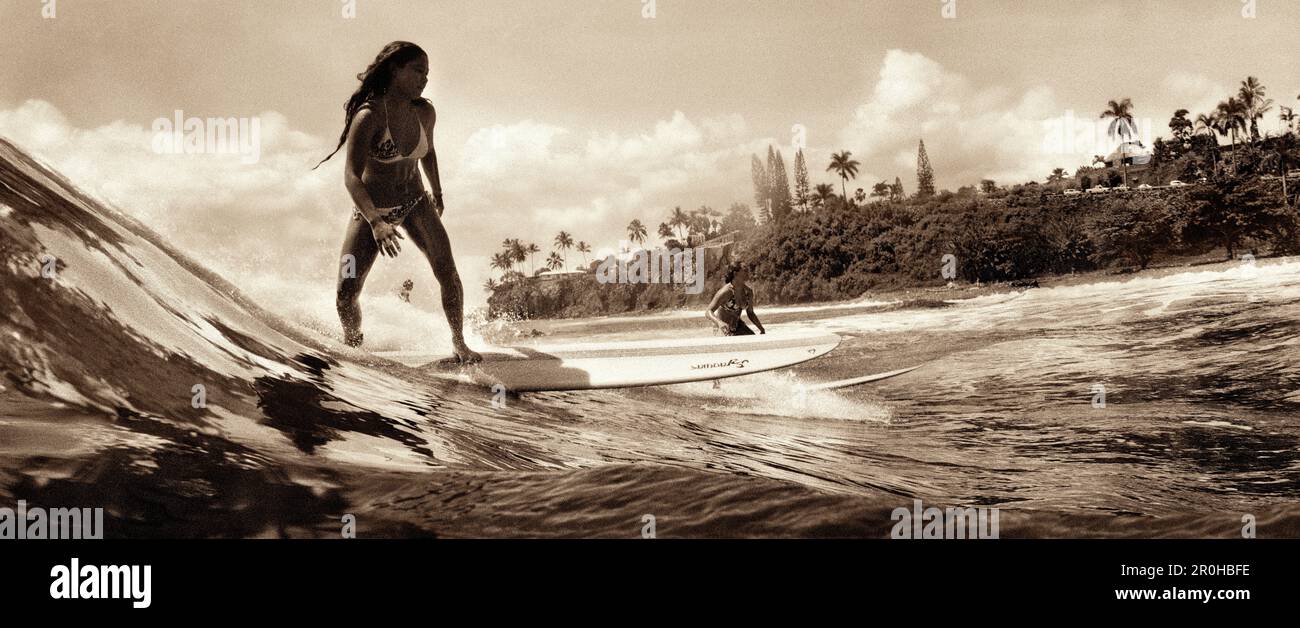 USA, Hawaii, Hilo, girls surf on a wave at Honoli'i beach, The Big