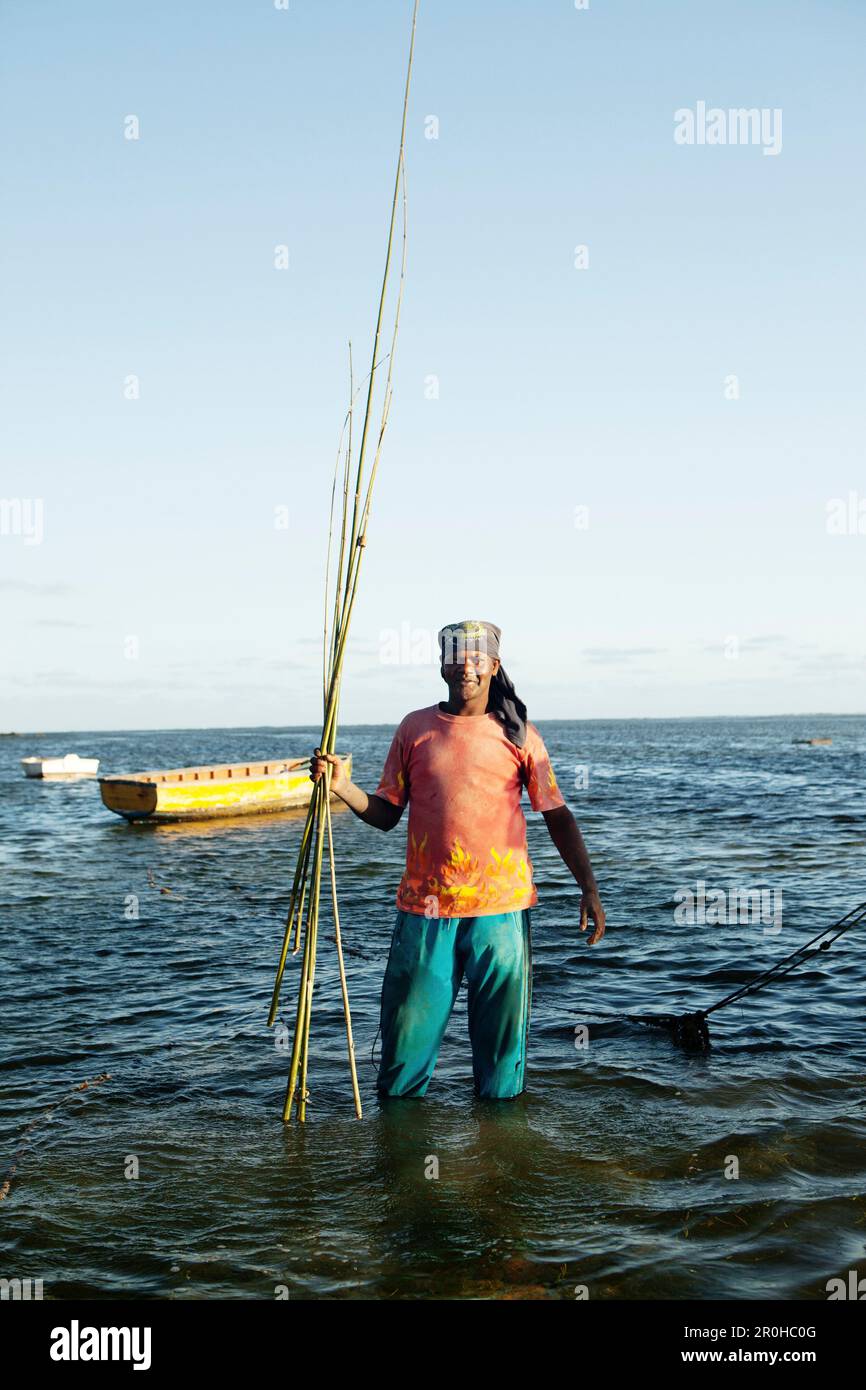 MAURITIUS, portrait of a fishermen with a bunch of handmade bamboo fishing  rods, following a lond day on the water, Bel Ombre, Indian Ocean Stock  Photo - Alamy