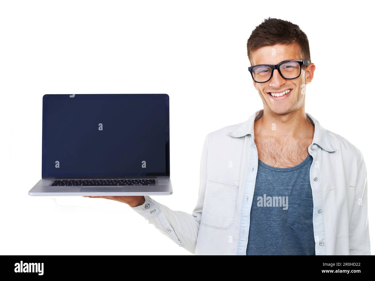 Introducing the latest laptop. A smiling casual male holding up a laptop. Stock Photo