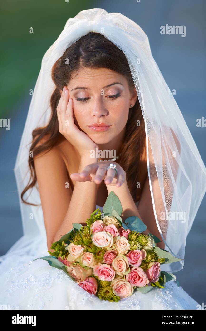Wedding day jitters. a young bride looking upset while sitting down and