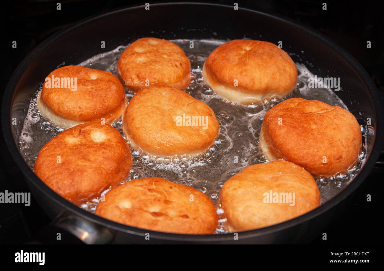 Traditional homemade polish donuts. Oil frying process Stock Photo Alamy