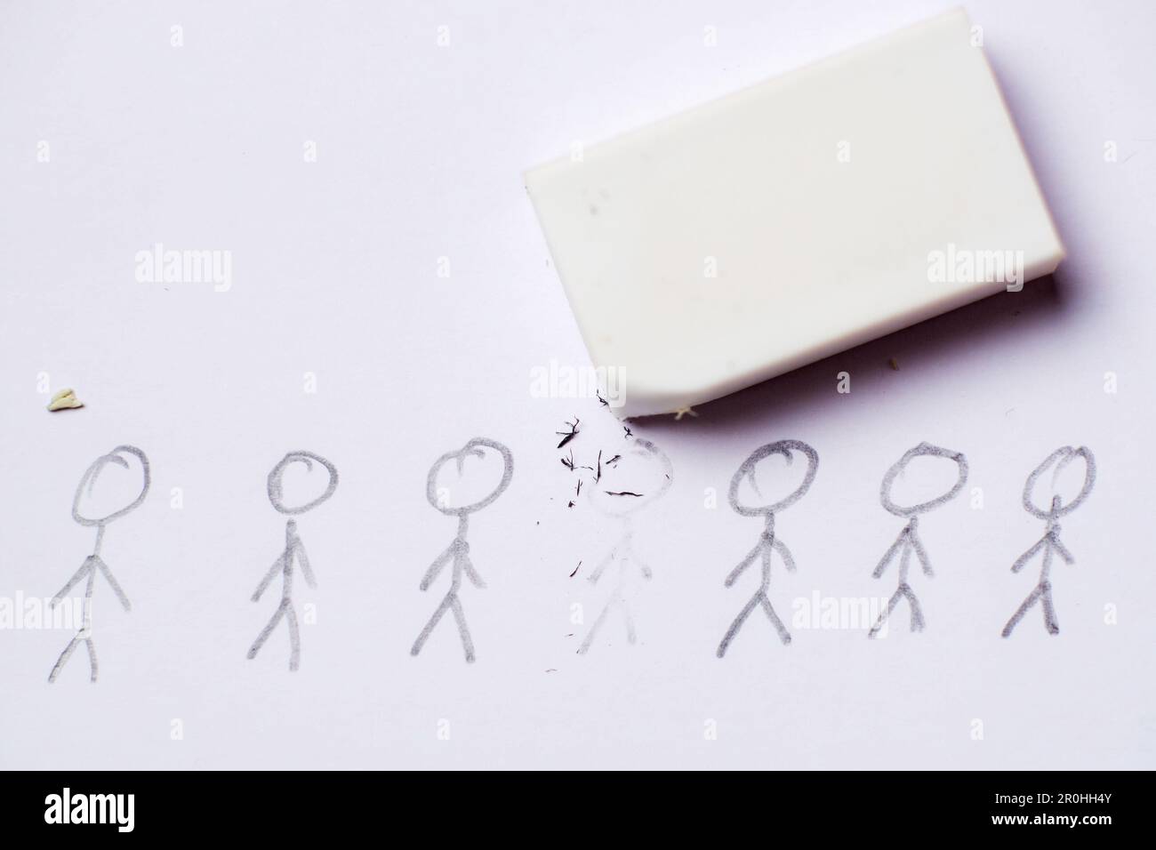 Cancellation culture concept. The drawn figure of a person is erased with an eraser. Stock Photo