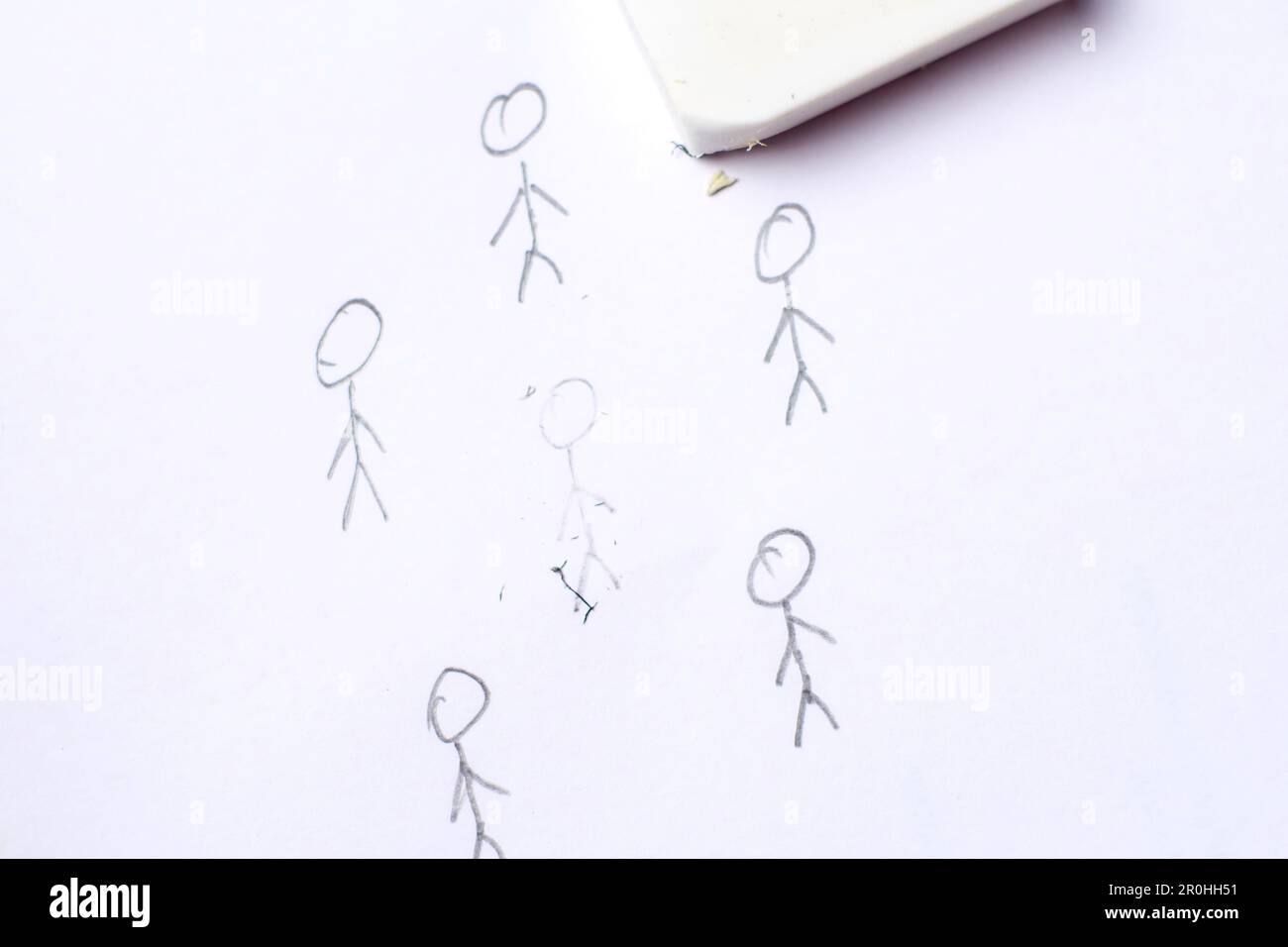 Cancellation culture concept. The drawn figure of a person is erased with an eraser. Stock Photo