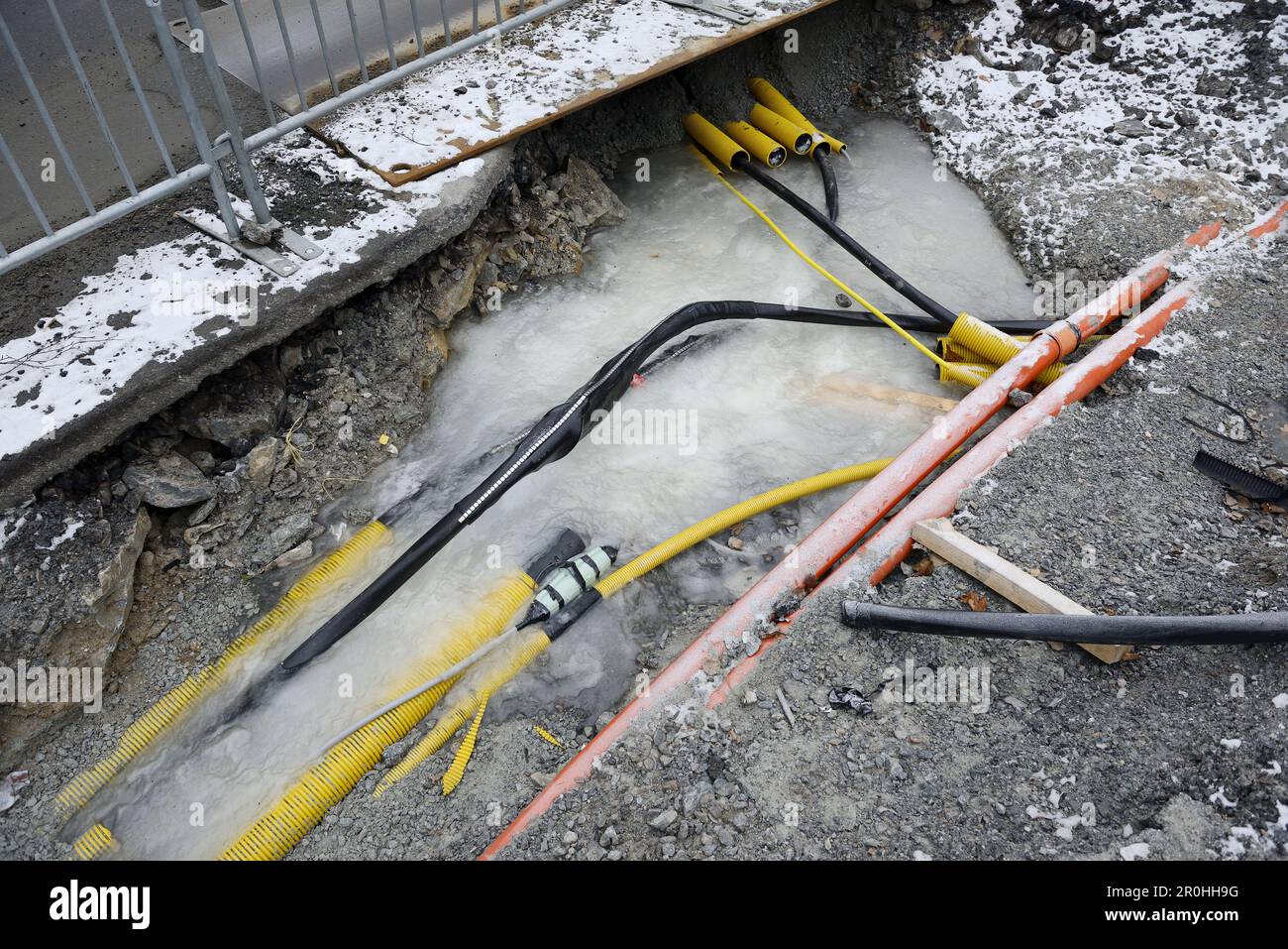 Workplace with frozen underground pipes and cables during wintertime
