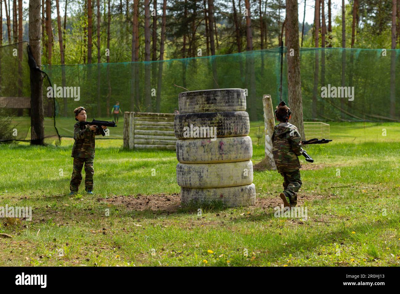 Weapon Tag Two boys weared in camouflage playing laser tag in special forest ...