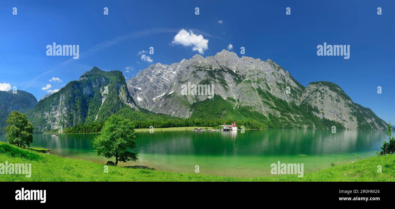 Panorama with view to lake Koenigssee and St. Bartholomae church, Hachelkoepfe, Watzmann with Watzmann East Face, Suedspitze, Mittelspitze and Hocheck Stock Photo
