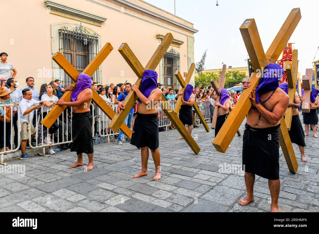 Good Friday Silent procession in Oaxaca Mexico during the Semana Santa  (Easter) / Participants with crosses wear hoods to create anonymity and symbolize equality before God Stock Photo
