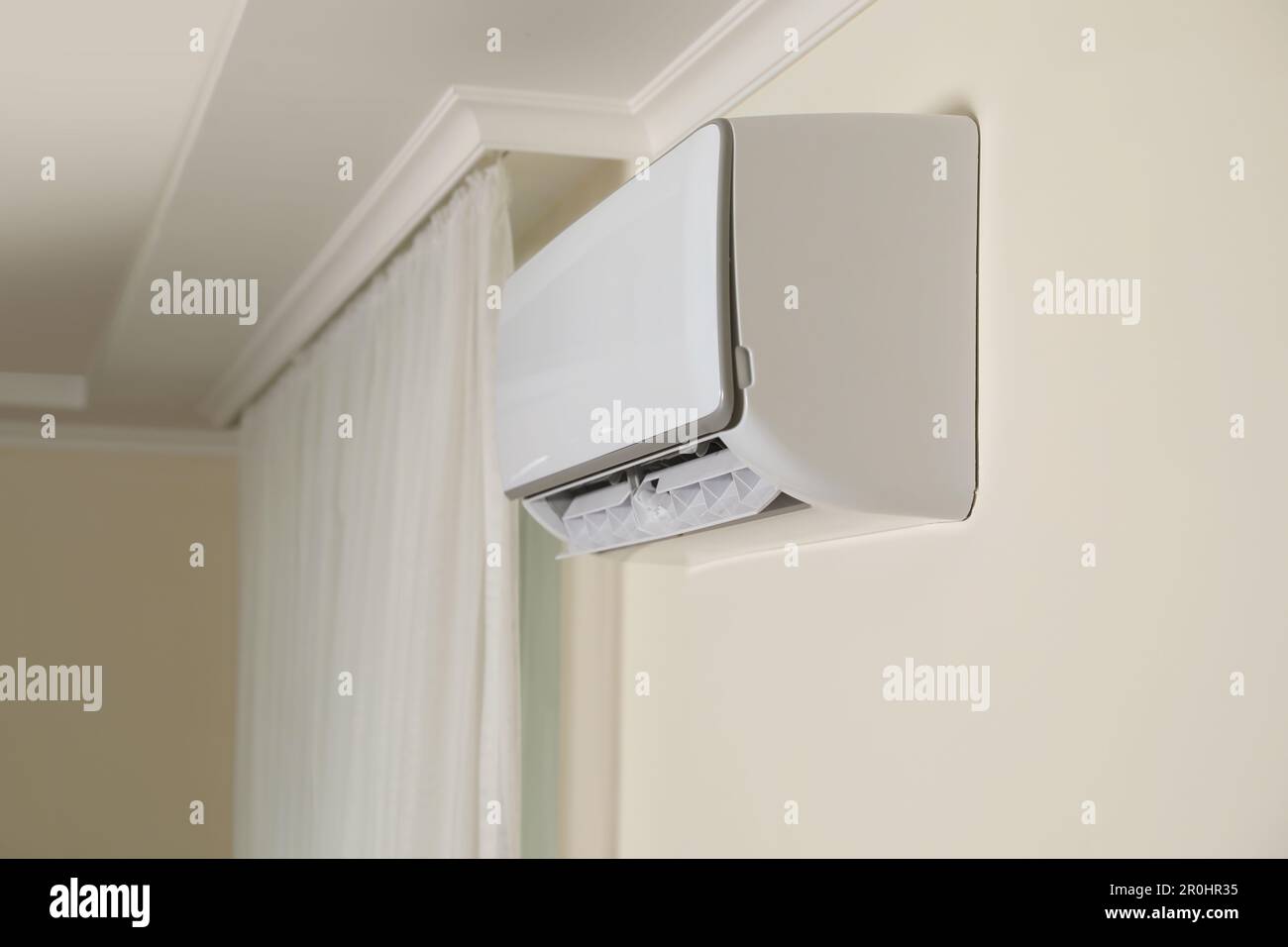 Modern air conditioner on white wall indoors Stock Photo - Alamy