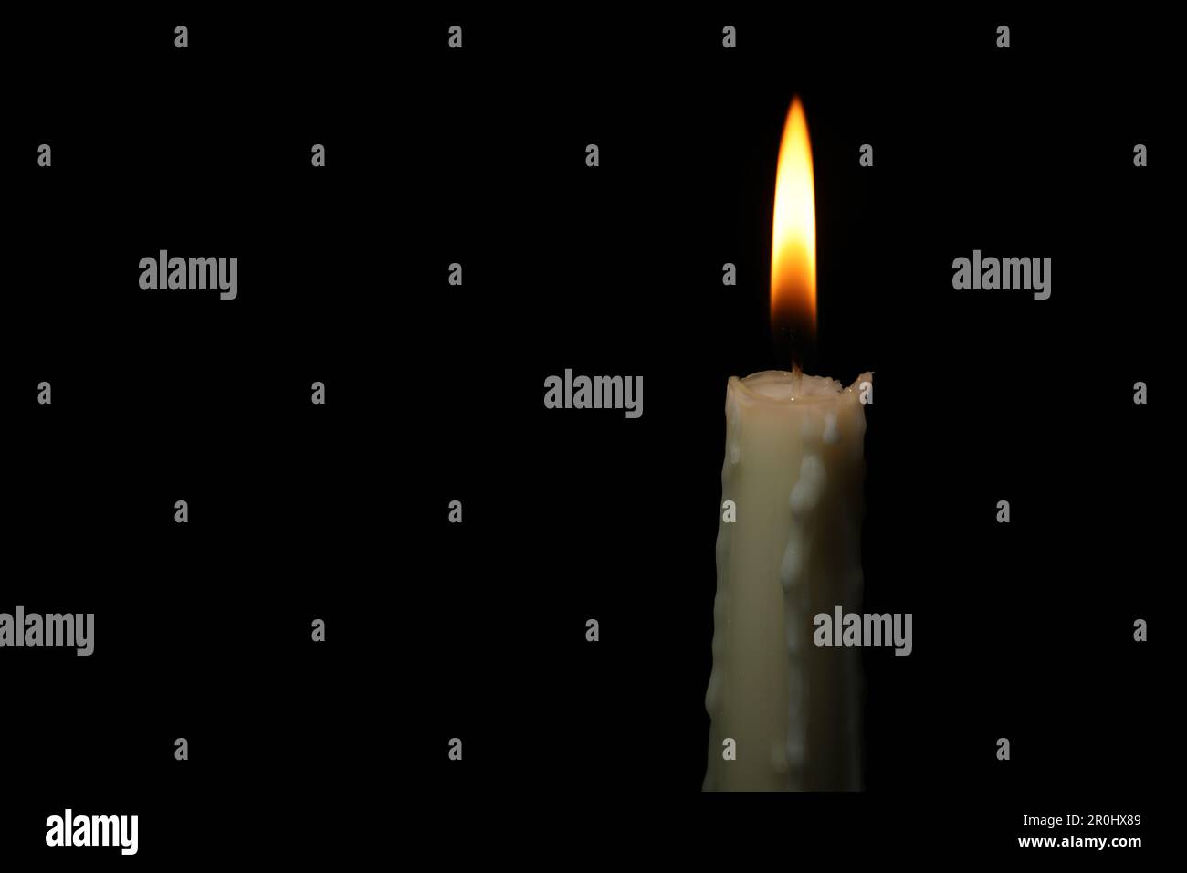 Burning wax candle on black background, closeup. Space for text Stock ...