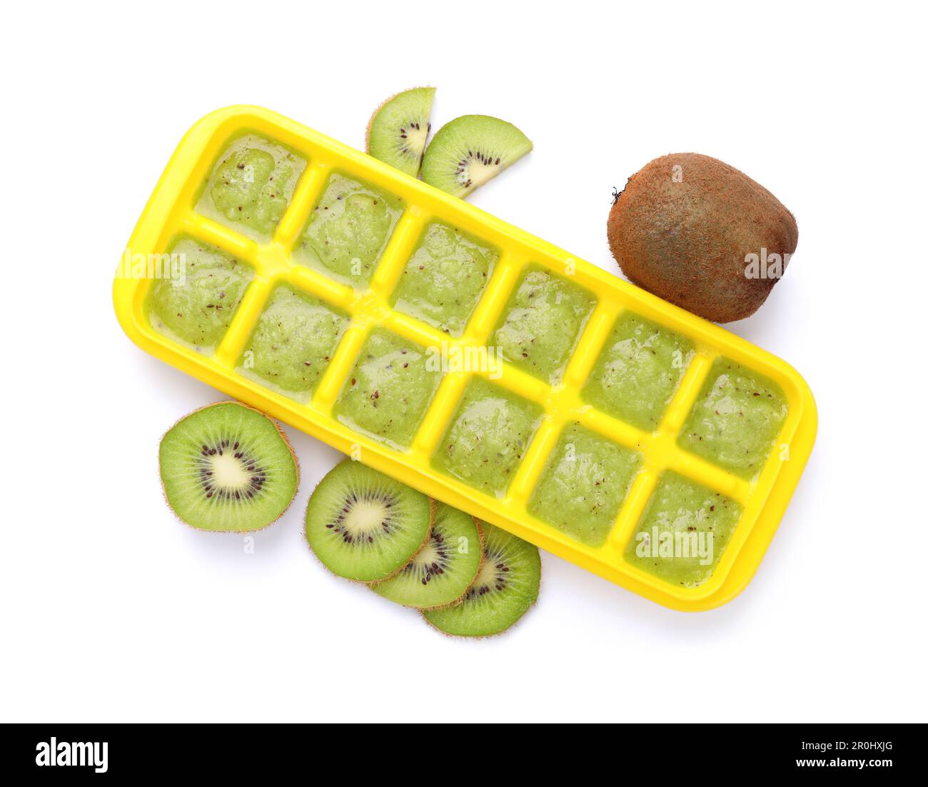 Kiwi puree in ice cube tray and fresh kiwi fruits isolated on white
