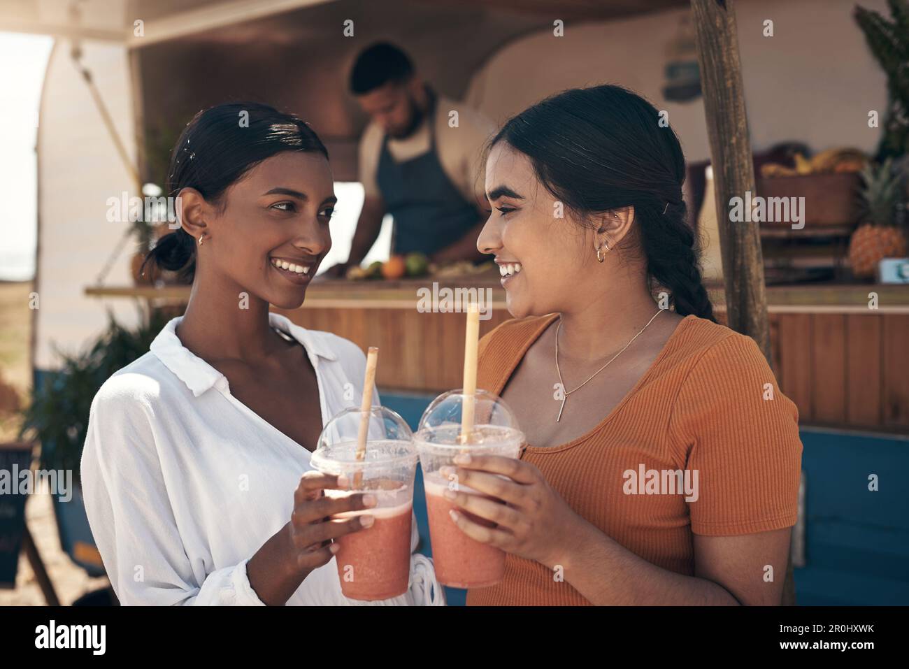 Cheers to us darling. two friends enjoying smoothies together Stock ...