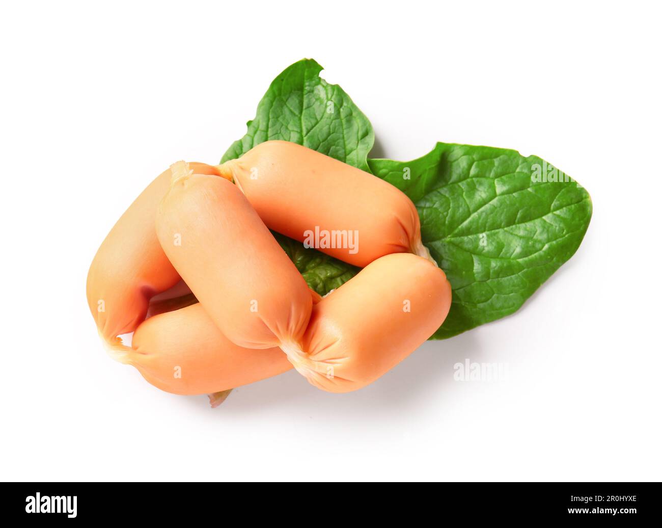 Tasty boiled sausages with spinach on white background Stock Photo