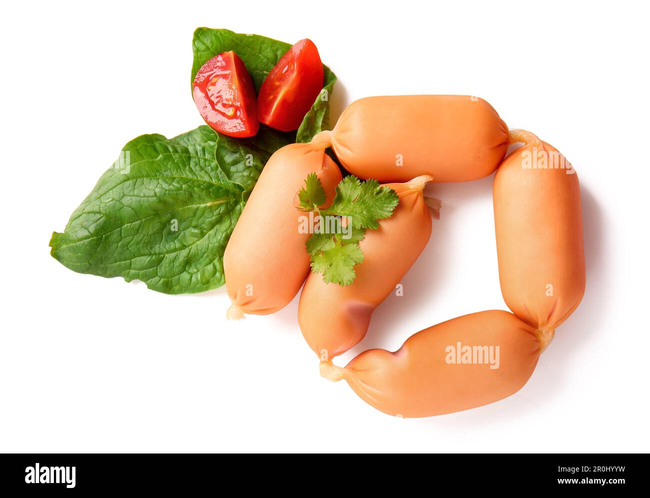 Tasty boiled sausages with parsley, tomato and spinach on white background Stock Photo
