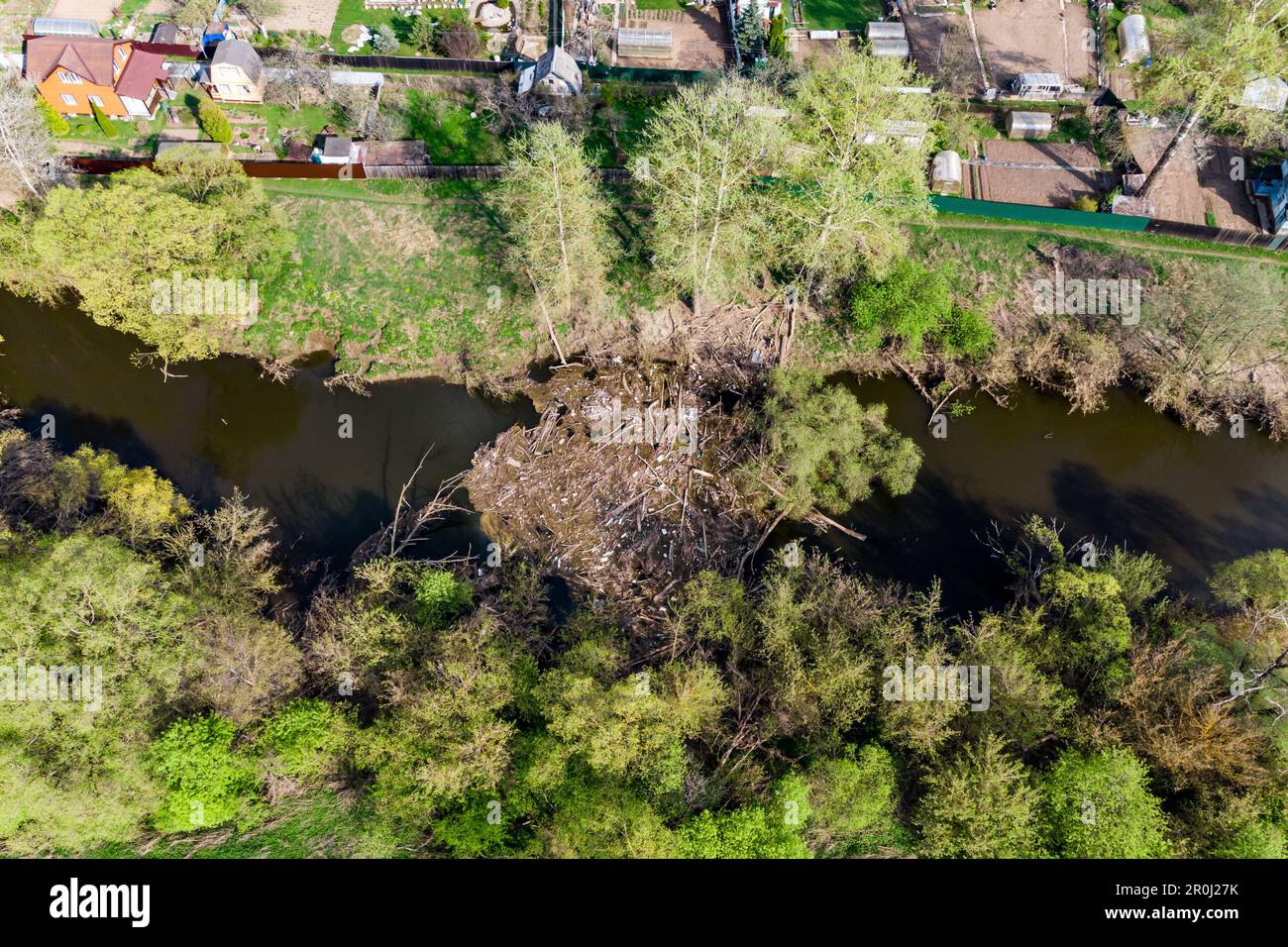 Floating pile of debris from branches and plastic accumulated in the