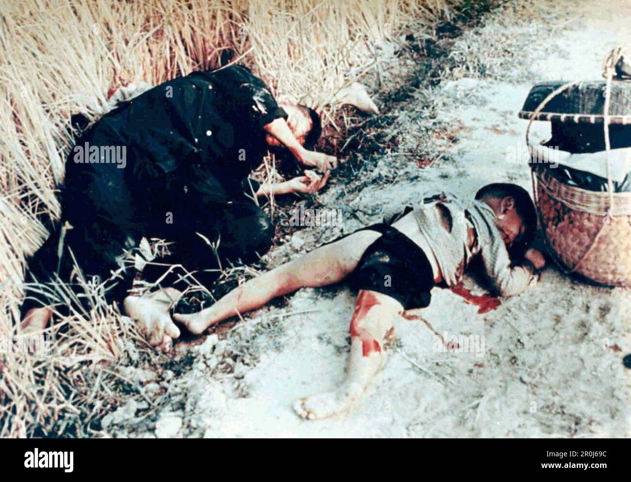 An unidentified man and child who were killed on a road at the Vietnamese village of My Lai after around 500 civilians were massacred by american troops during thh Vietnam War. Stock Photo