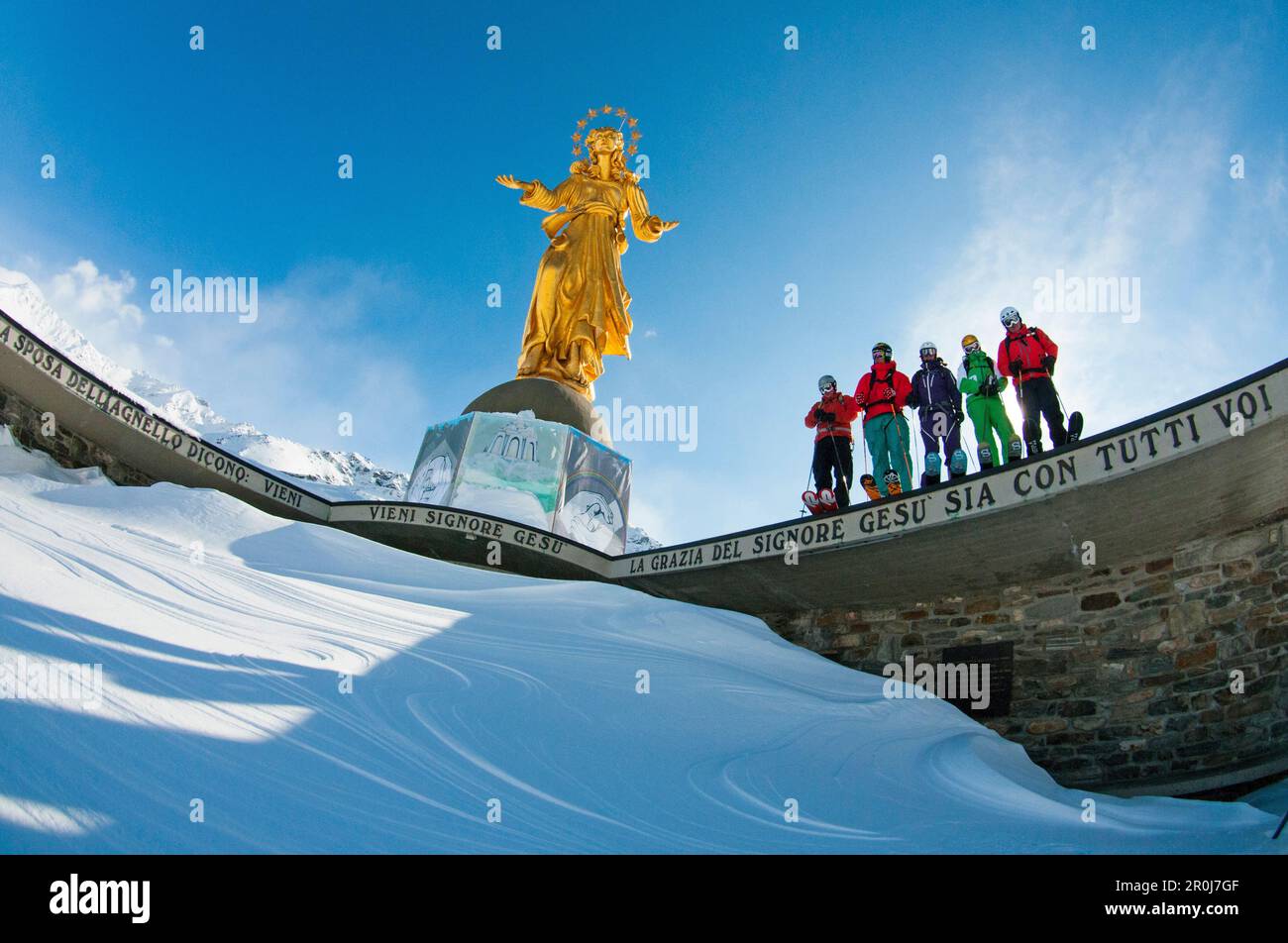 Skier in front of a golden madonna, Madesimo, Italy Stock Photo