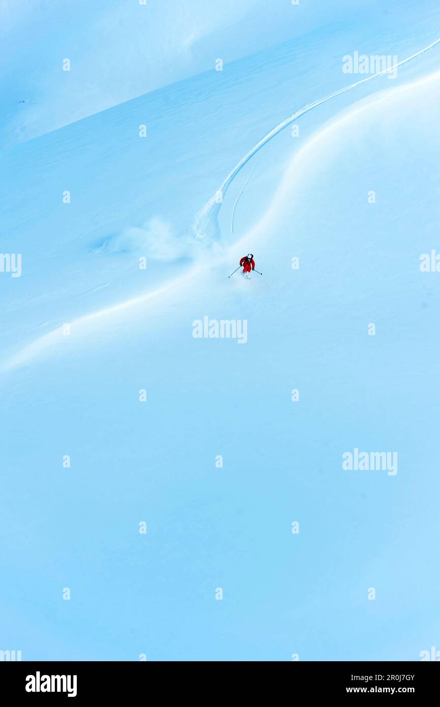 Skier jumping over a windlip on a wide open field, Gargellen, Vorarlberg, Austria Stock Photo