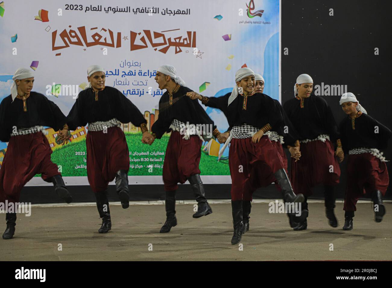 (230509) -- GAZA, May 9, 2023 (Xinhua) -- Students perform during a cultural event at the Culture and Free Thought Association in the southern Gaza Strip city of Khan Younis, on May 8, 2023. Dozens of children on Monday in the Gaza Strip took part in a cultural event aimed at encouraging their peers to read and learn. 'This event was organized as part of an integrated program of cultural activities dedicated to children in order to encourage them to read and learn,' Mariam Zaqout, General Director of the Culture and Free Thought Association (CFTA), the sponsor and organizer, told Xinhua. (Phot Stock Photo