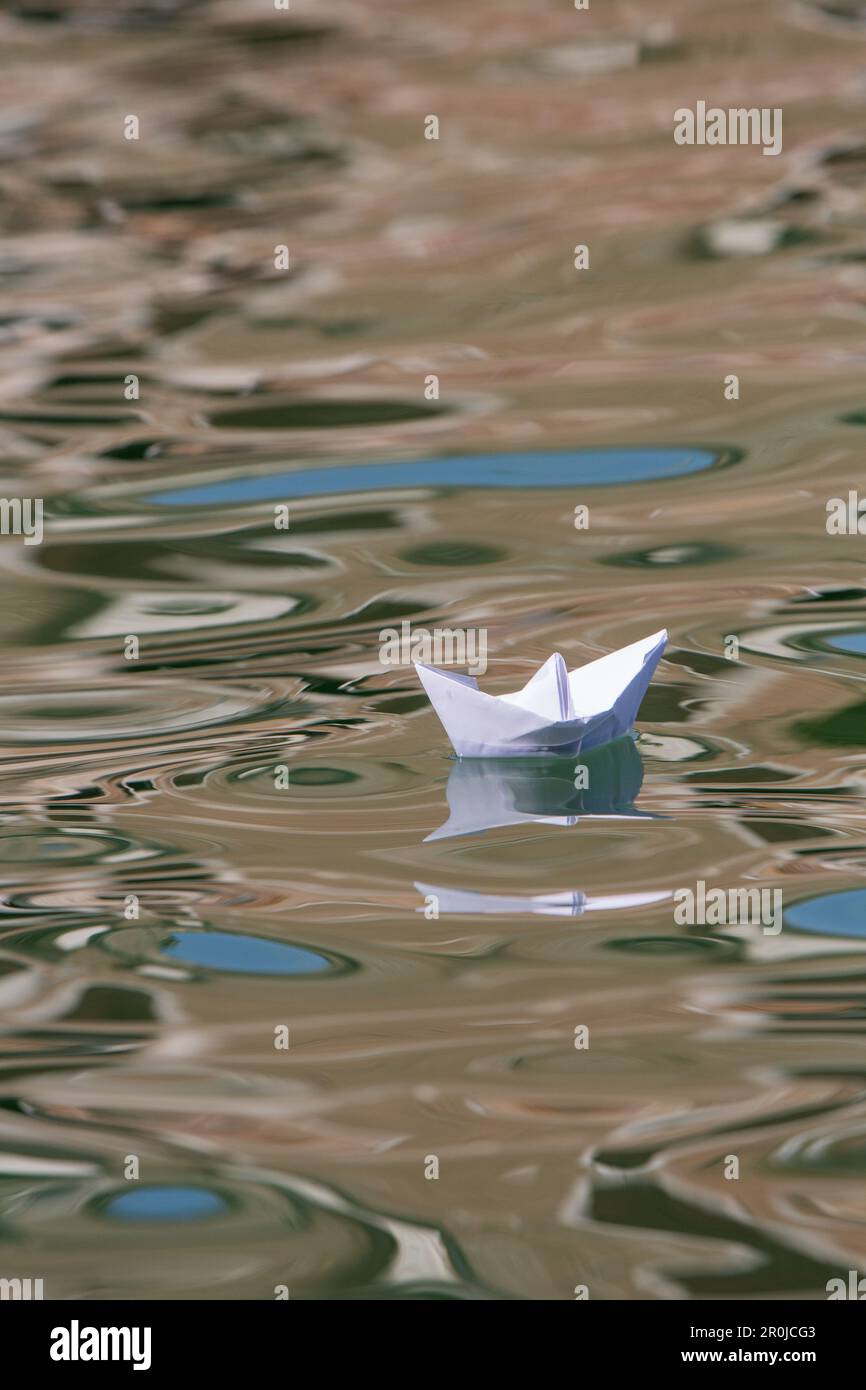 paper boat, white, reflections, water, canal, slow travel, Venice, Italy Stock Photo