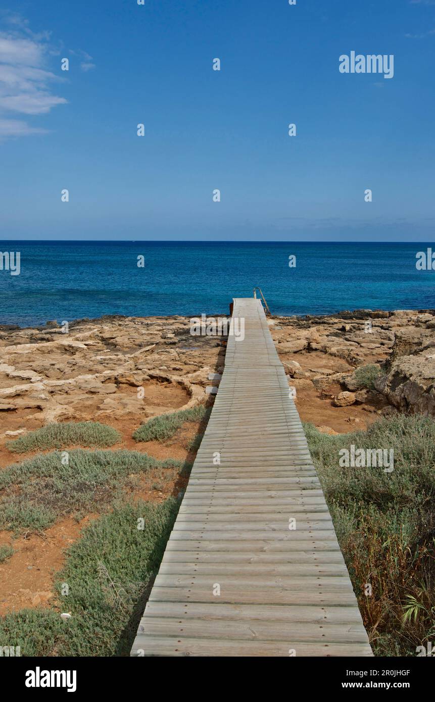 lonesome coast with wooden gangway on the rocky coast at Paralimni, Larnaca District, Cyprus Stock Photo