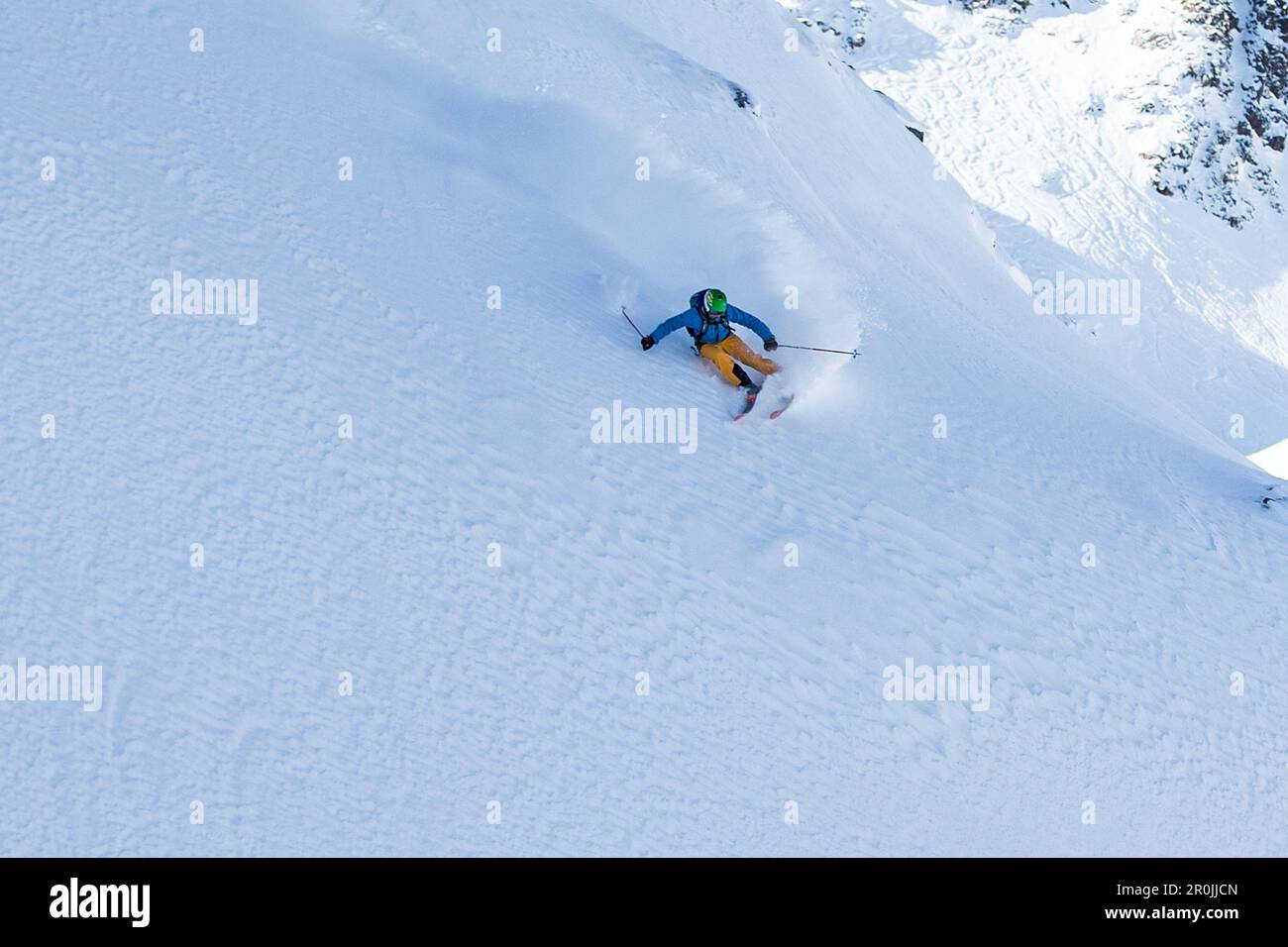 Young male freeskier riding through the deep powder snow in the mountains, Pitztal, Tyrol, Austria Stock Photo