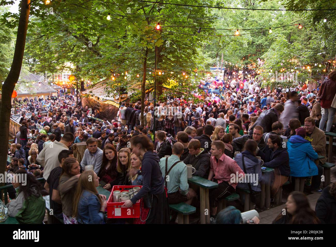 People sit outside in beer garden and enjoy the Erlanger Bergkirchweih