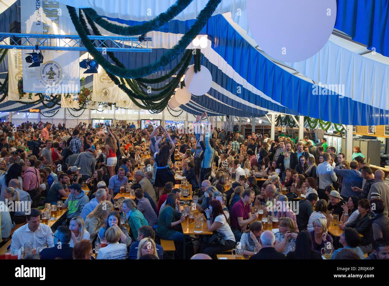 People celebrate in giant beer tent at Bayreuther Volksfest beerfest ...