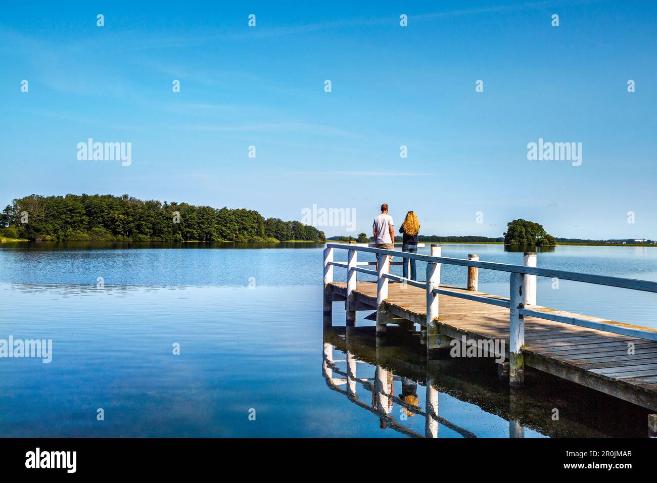 Couple on a pier at lake Ploen, Bosau, Holstein Switzerland, Ostholstein, Schleswig-Holstein, Germany Stock Photo