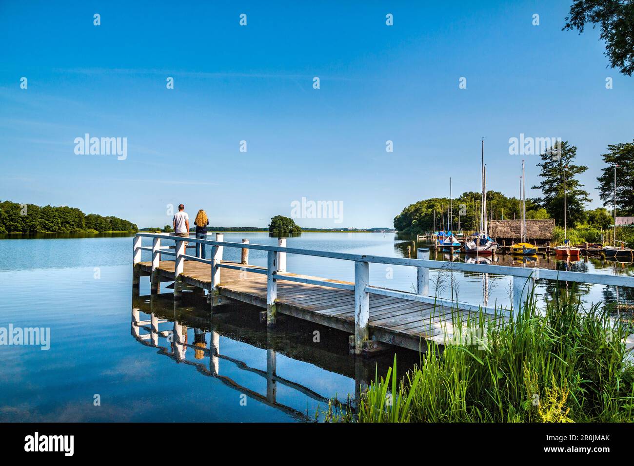 Couple on a pier at lake Ploen, Bosau, Holstein Switzerland, Ostholstein, Schleswig-Holstein, Germany Stock Photo