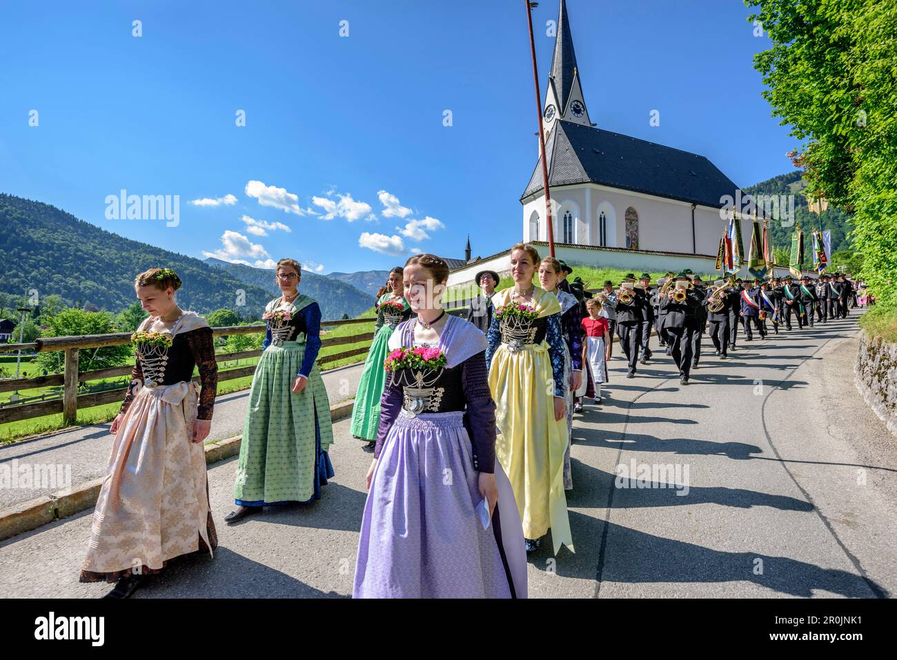 Procession during religious festival of Feast of Corpus Christi, church of Kreuth in background, Kreuth, Bavarian Alps, Upper Bavaria, Bavaria, German Stock Photo