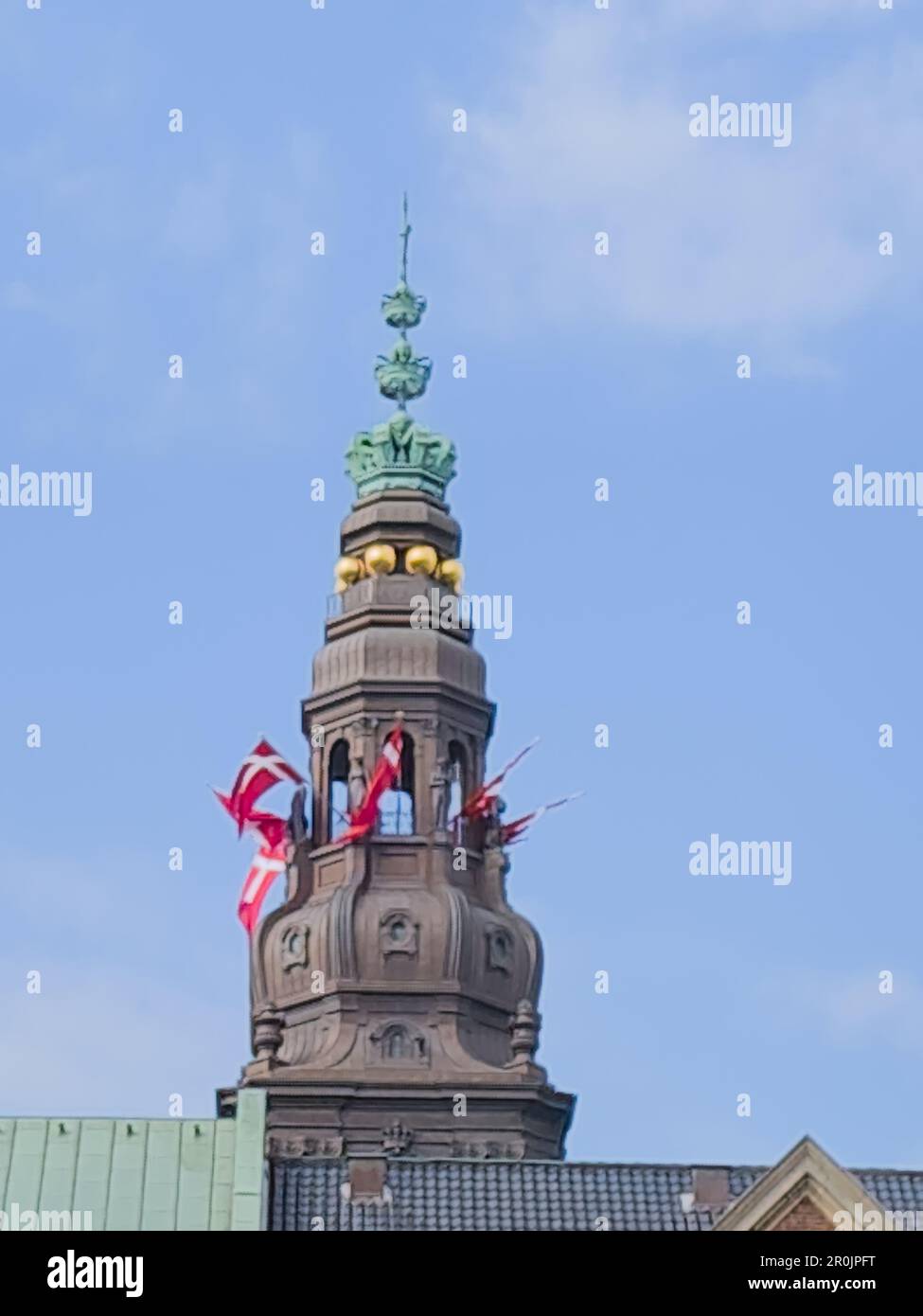 Baroque tower close up view on top of the Borg Danish parliament with Danish flags Stock Photo