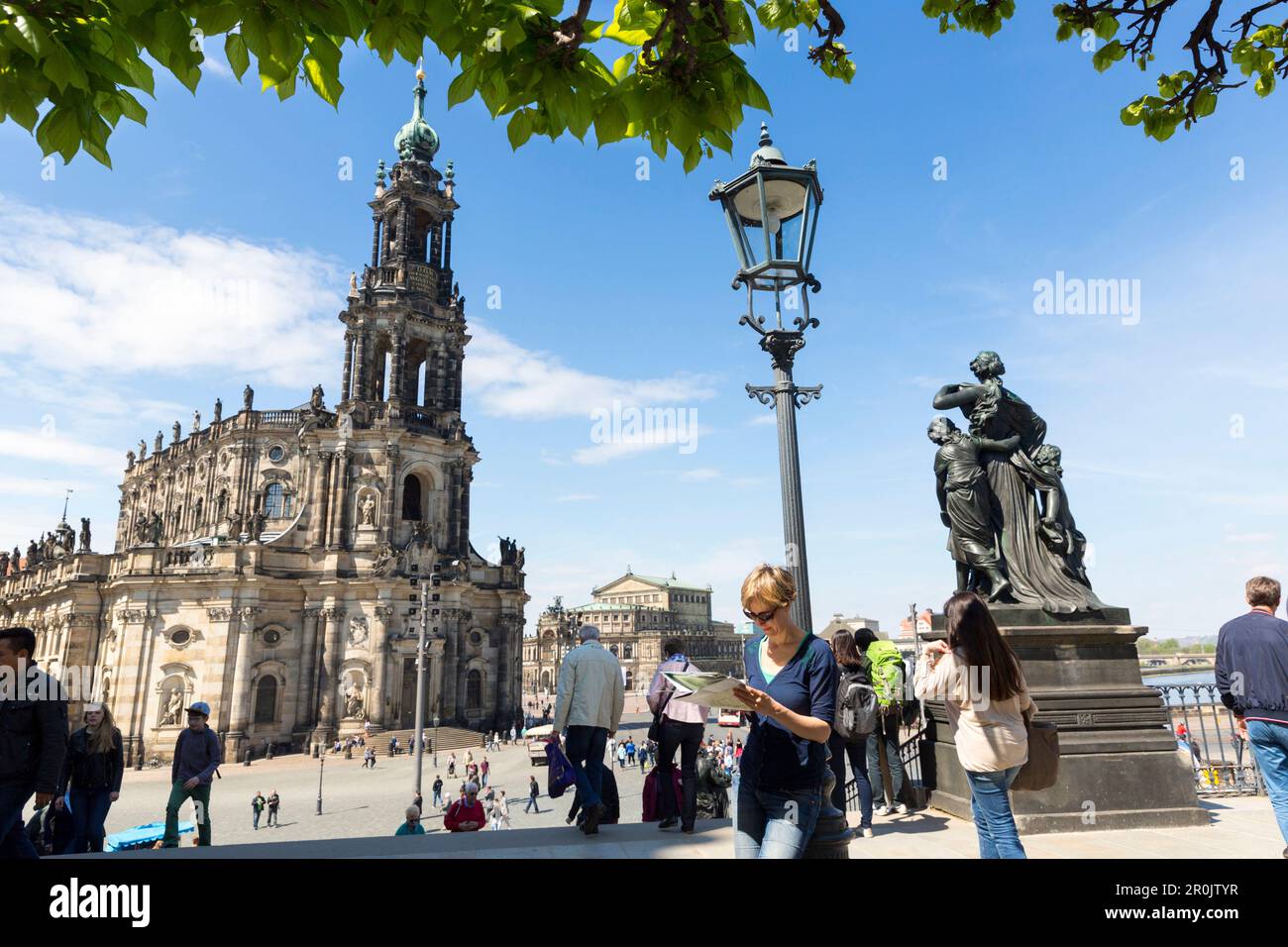 Female tourist with city map, guide book, view from Bruehl's Terrace, Dresden cathedral, Catholic Court Church, Semper Opera House, MR, Dresden, Saxon Stock Photo