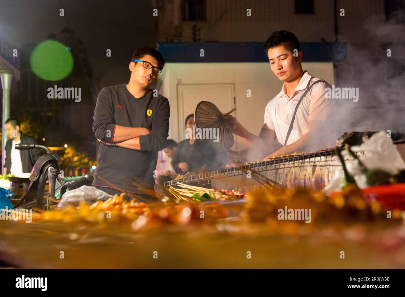 Barbecue, BBQ at night, two men, sticks, shaokao, asian food, street food, Shanghai, China, Asia
