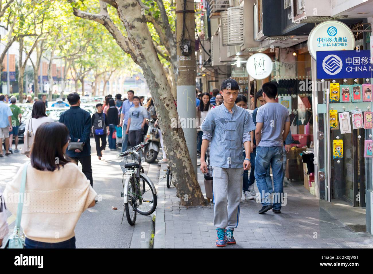 Tianzifang, young man, China mobile store, plane trees, shopping street, French Concession area, Shanghai, China, Asia Stock Photo
