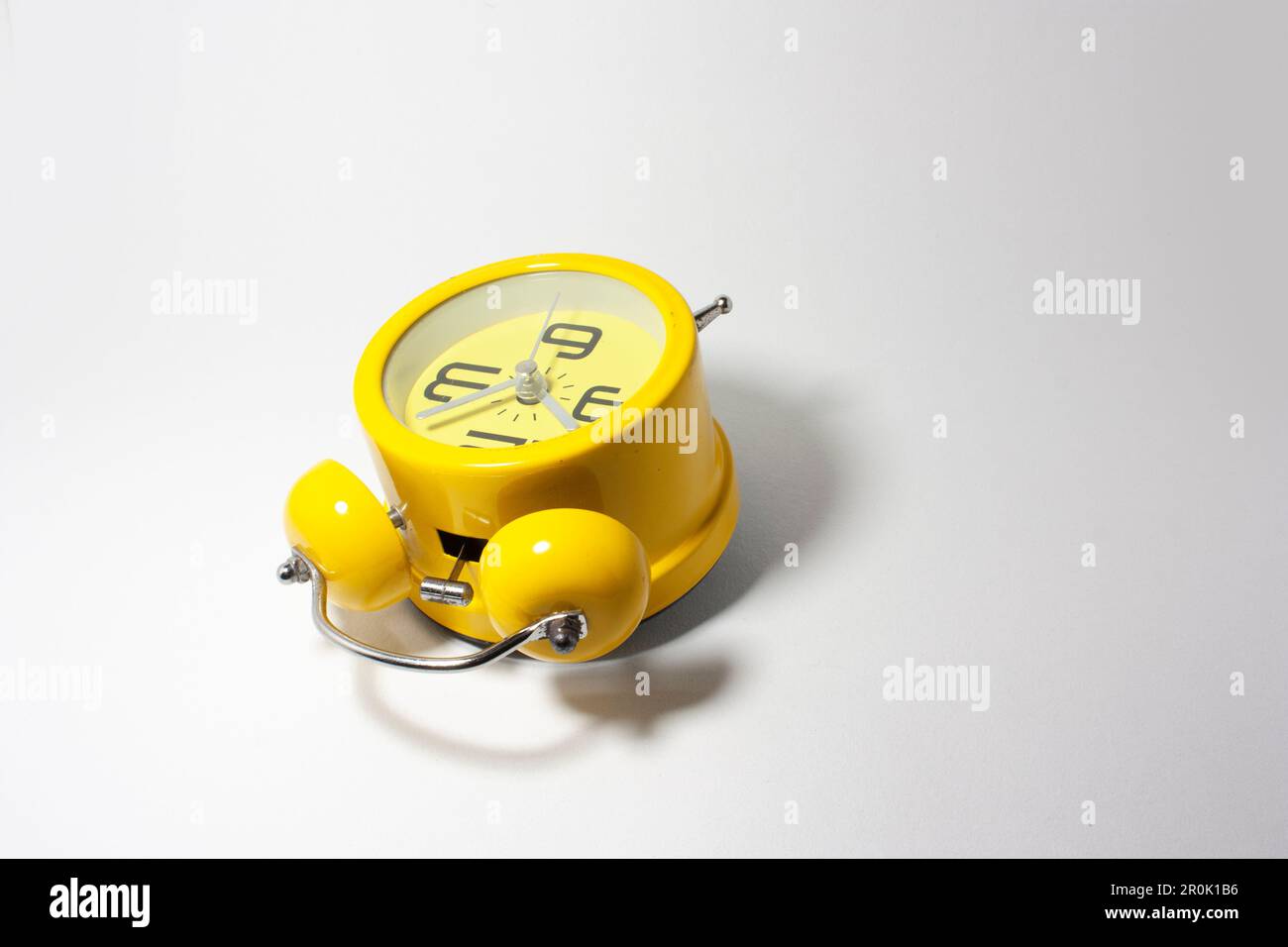 alarm clock yellow on white background Stock Photo - Alamy