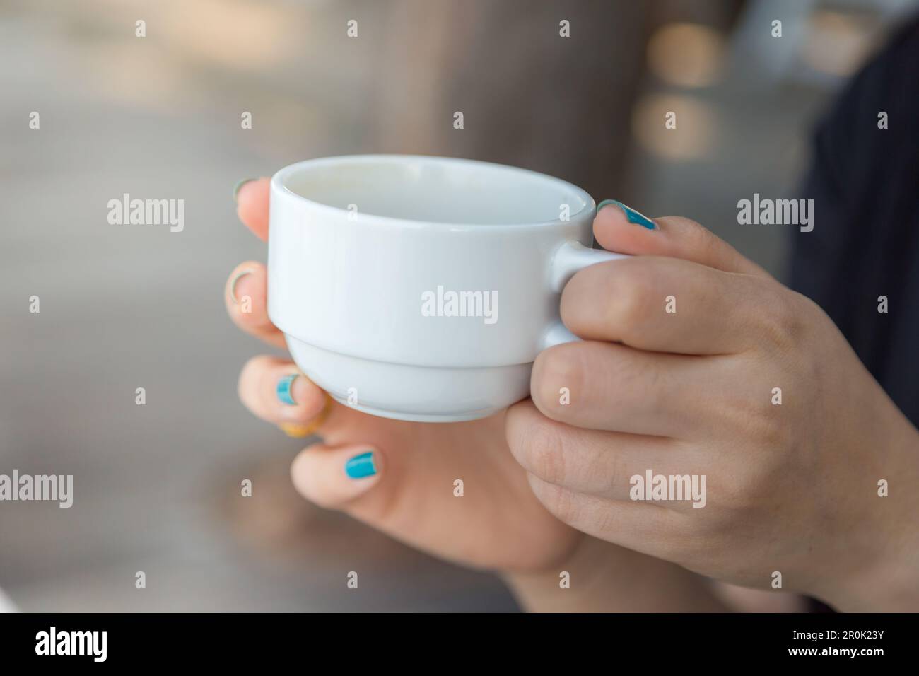 Woman drinking coffee in hand with blur baclground Stock Photo