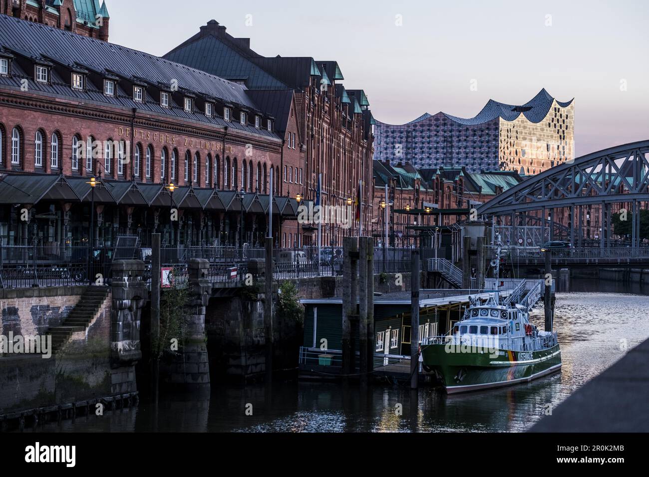 Hamburgs new Elbphilharmonie and old trading houses in the twilight